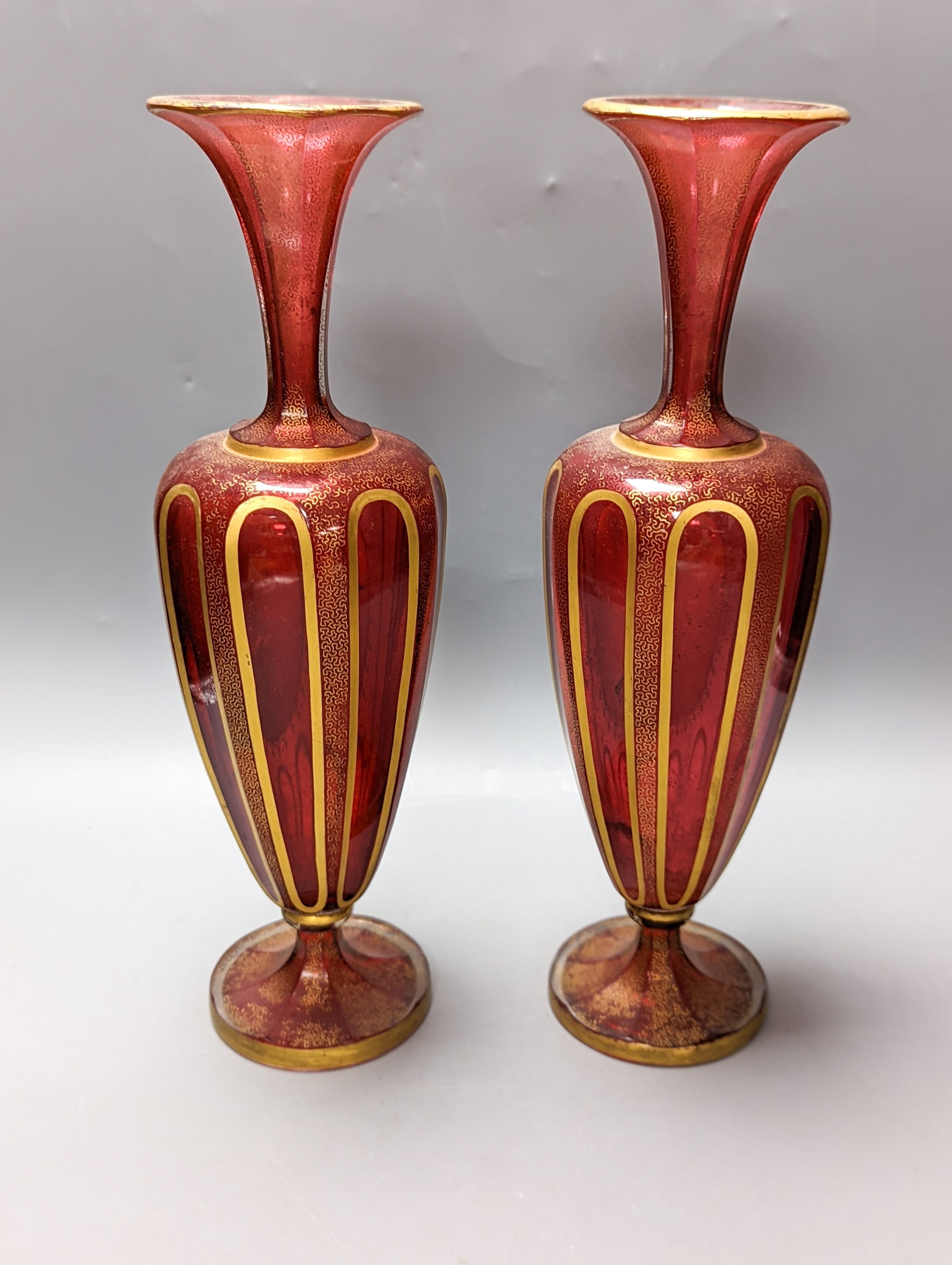 A pair of Bohemian enamelled and overlaid cranberry glass vases, 19th century 35cm